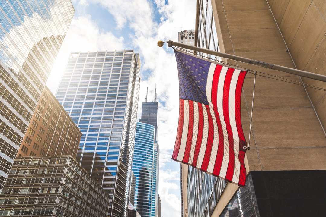 U.S. flag hanging next to a building