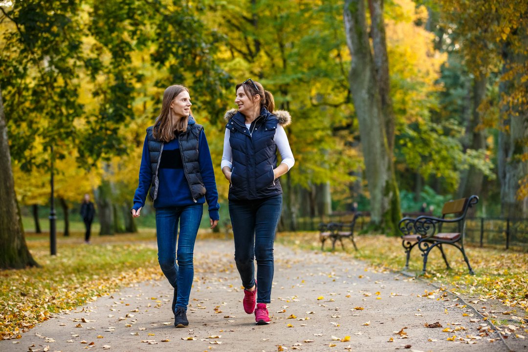 2 women going for a walk in the city park