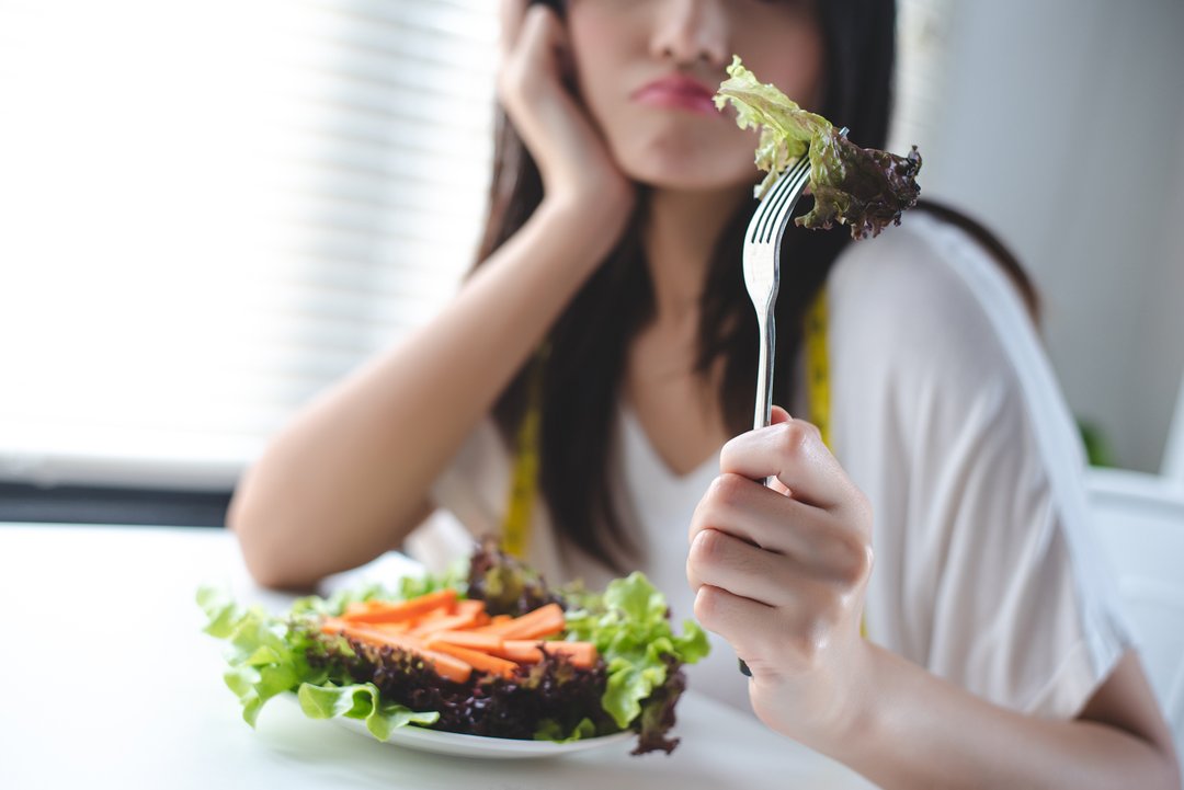 woman tired of eating healthy and unsustainable goals