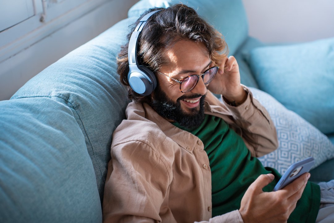 young man listening to music on headphones