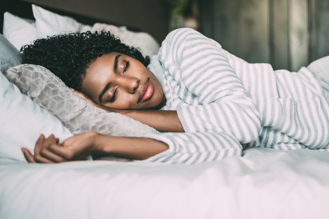 woman smiling while she sleeps