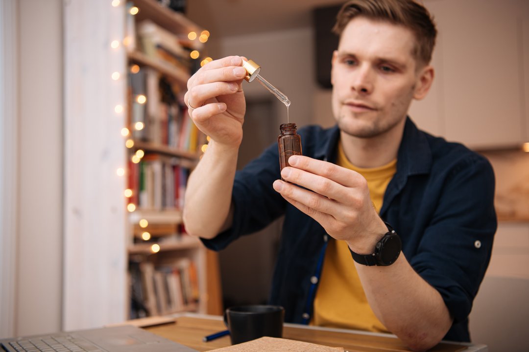 man using a THC tincture