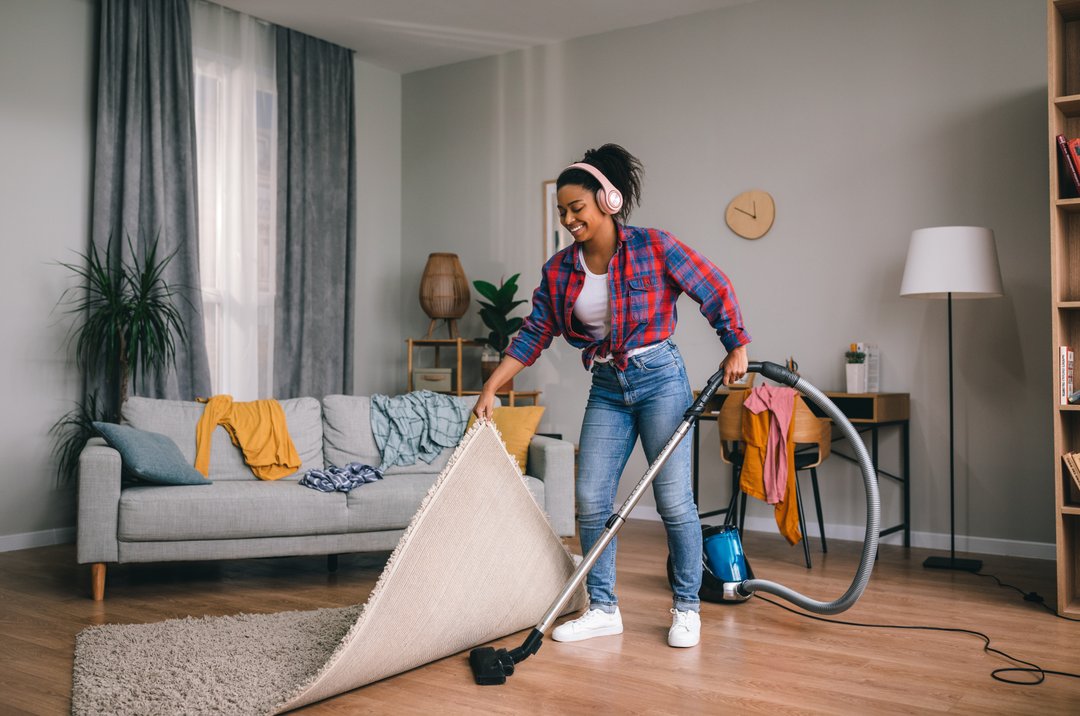 Woman vacuuming happily.