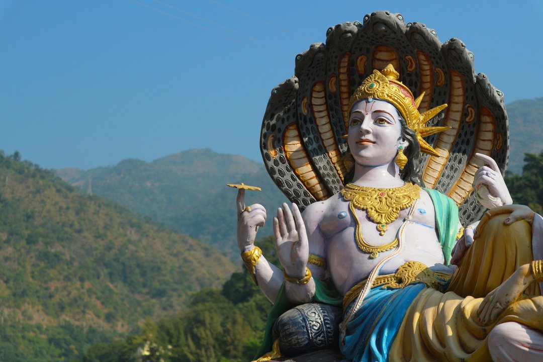 A sculpture of the Indian supreme god Vishnu on the banks of the Ganges River in Rishikesh