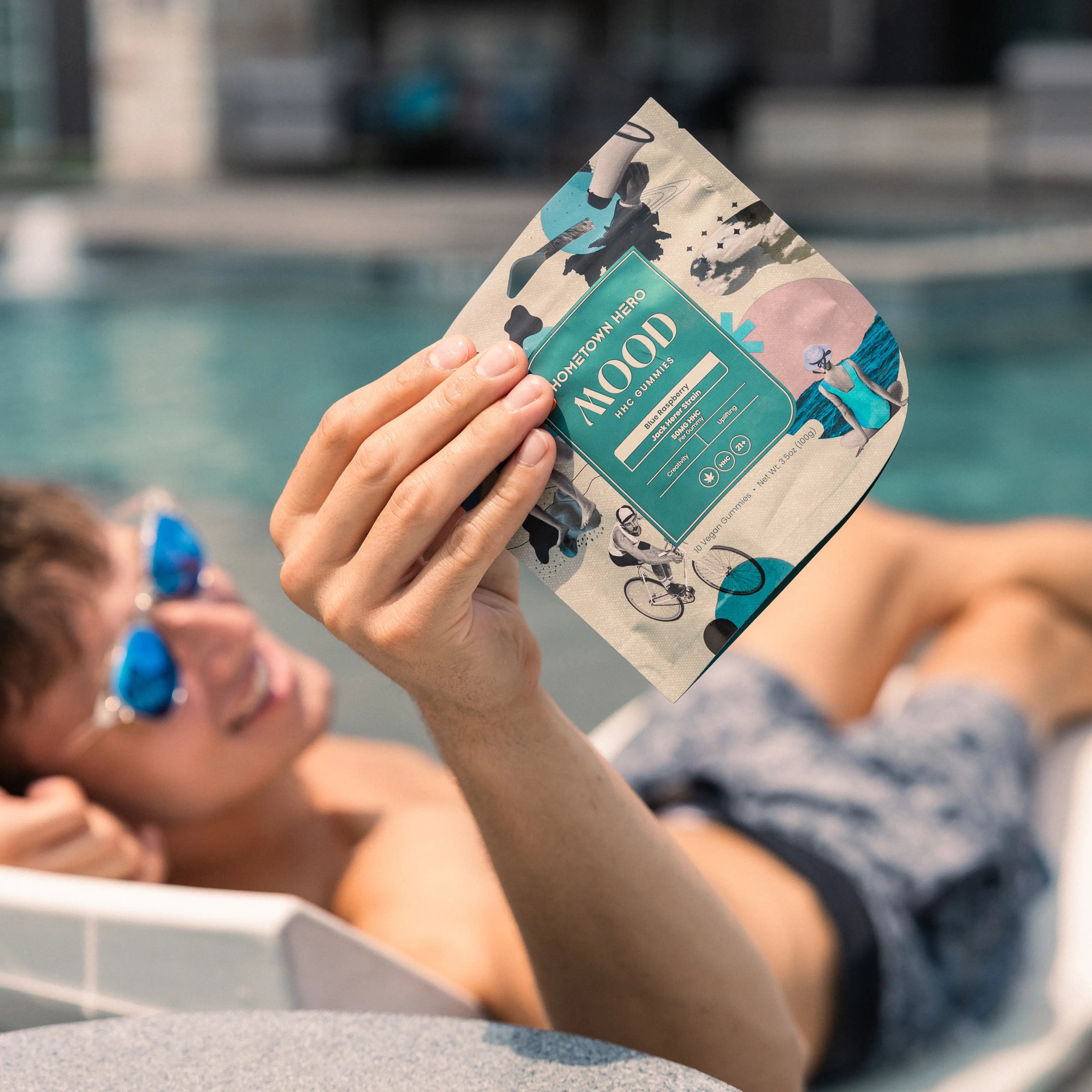 Man by the pool with a bag of gummies