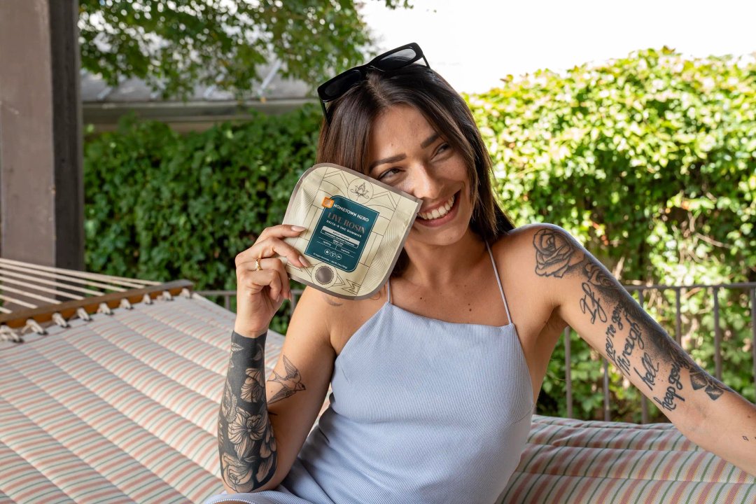 woman smiling holding some edibles