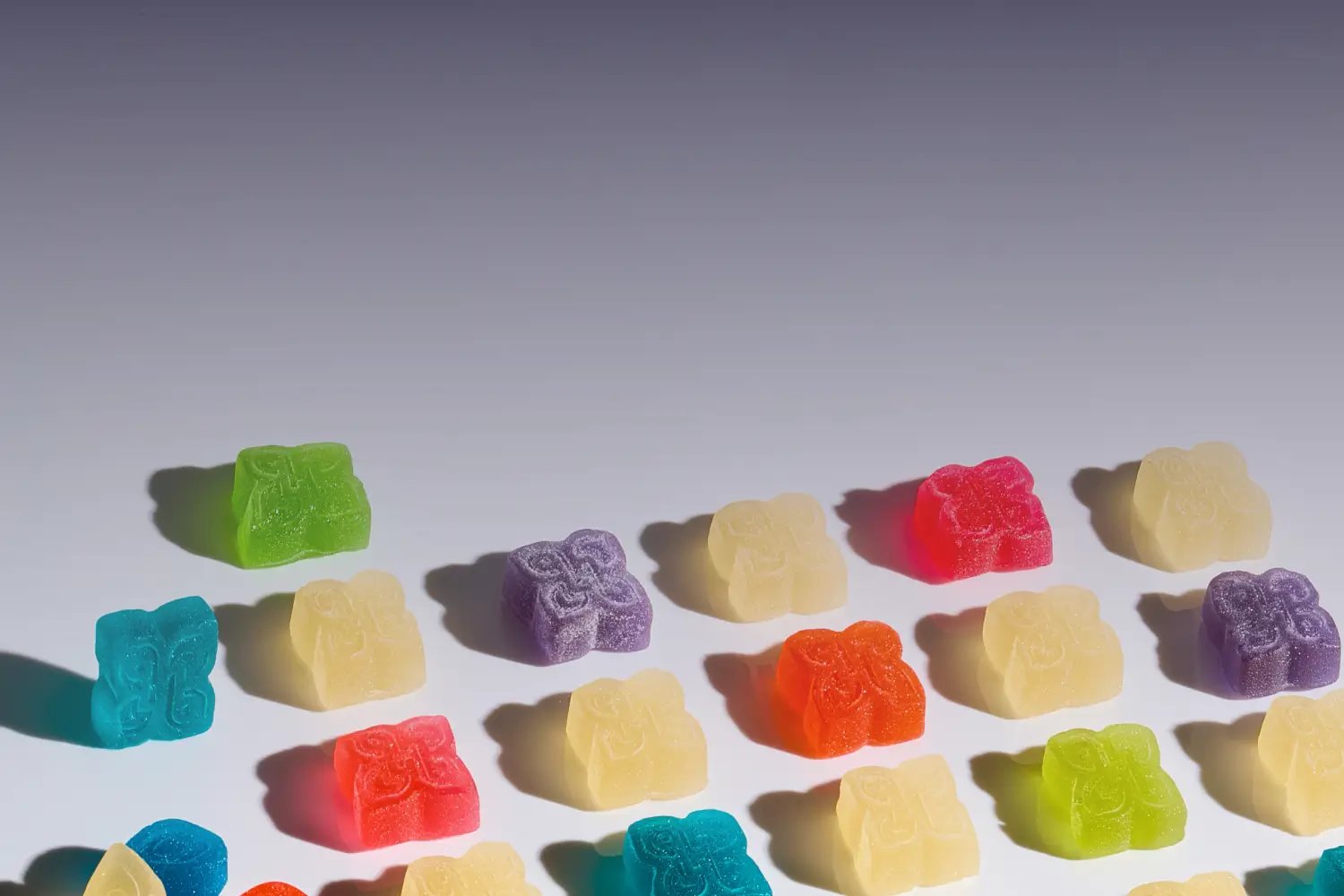 Assortment of THC-infused gummies in various colors, potencies, and shapes