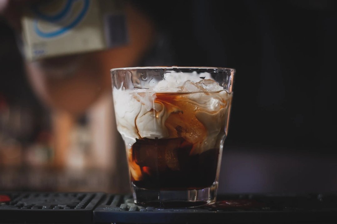 White Russian cocktail with cream mixed in