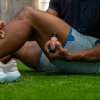 Man applying roll-on to his thigh