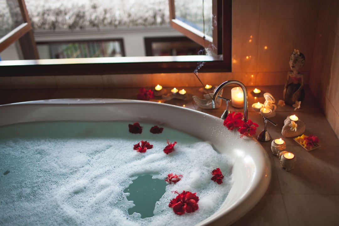 bath soaked with roses and candles