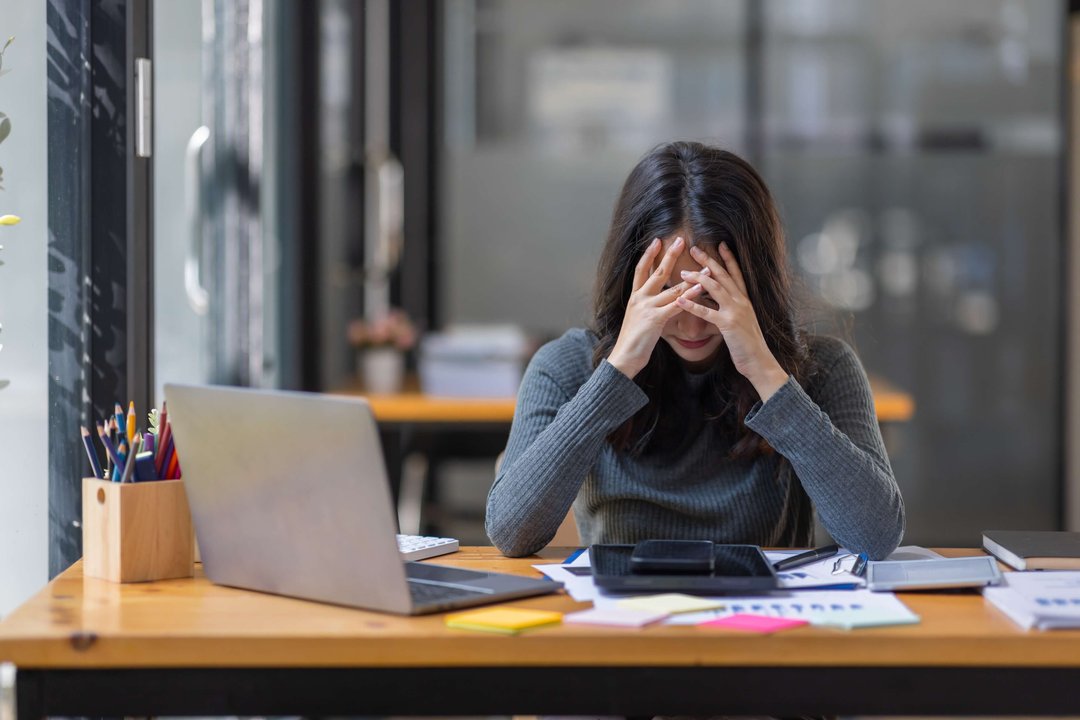 woman burned out at desk