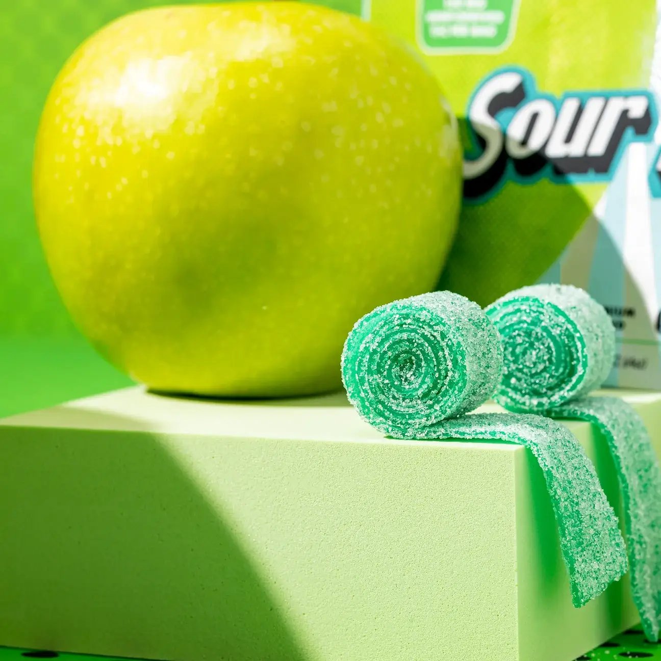 Atomic Apple Sour Belts candies and green apple