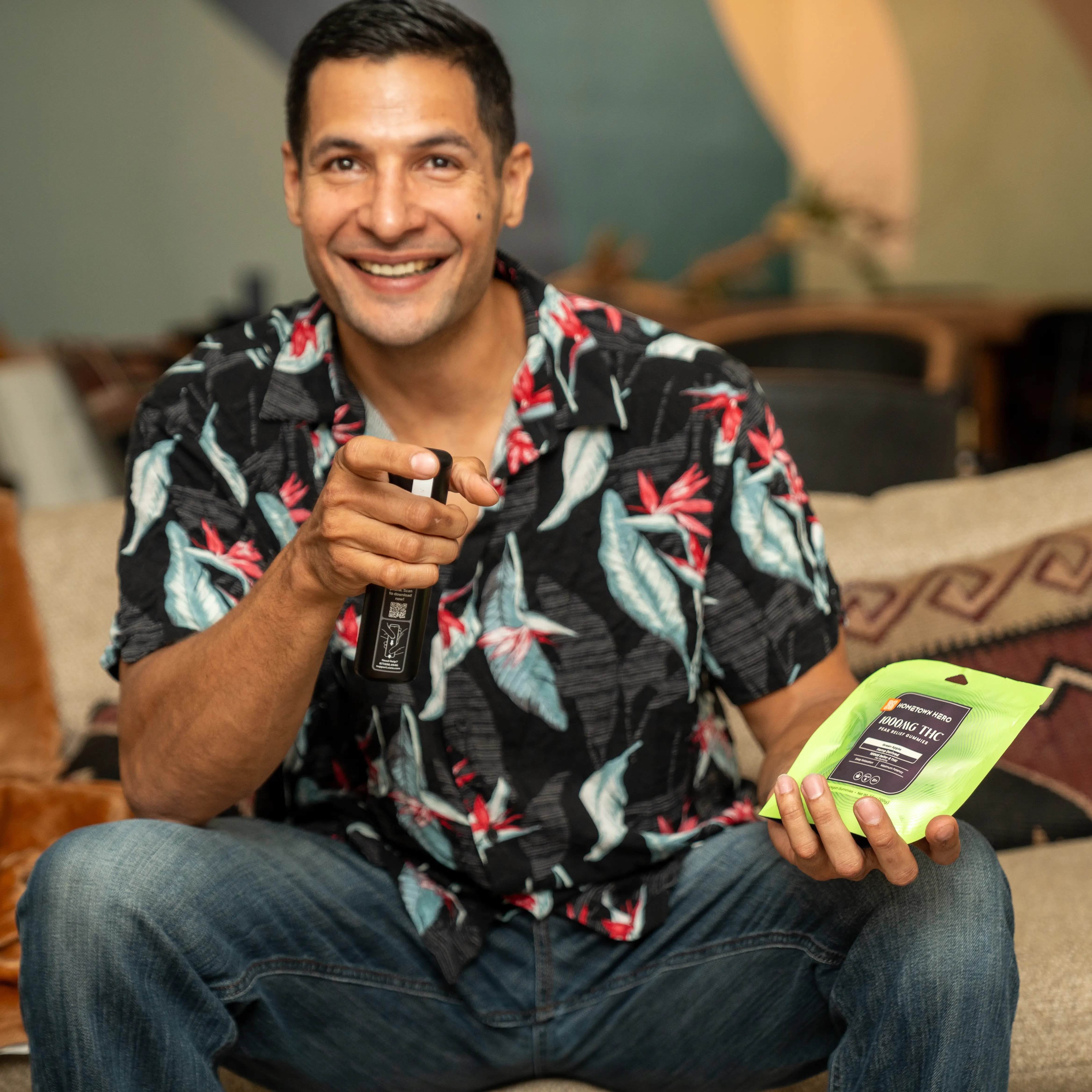 Man watching tv holding a bag of Hometown Hero Gummies