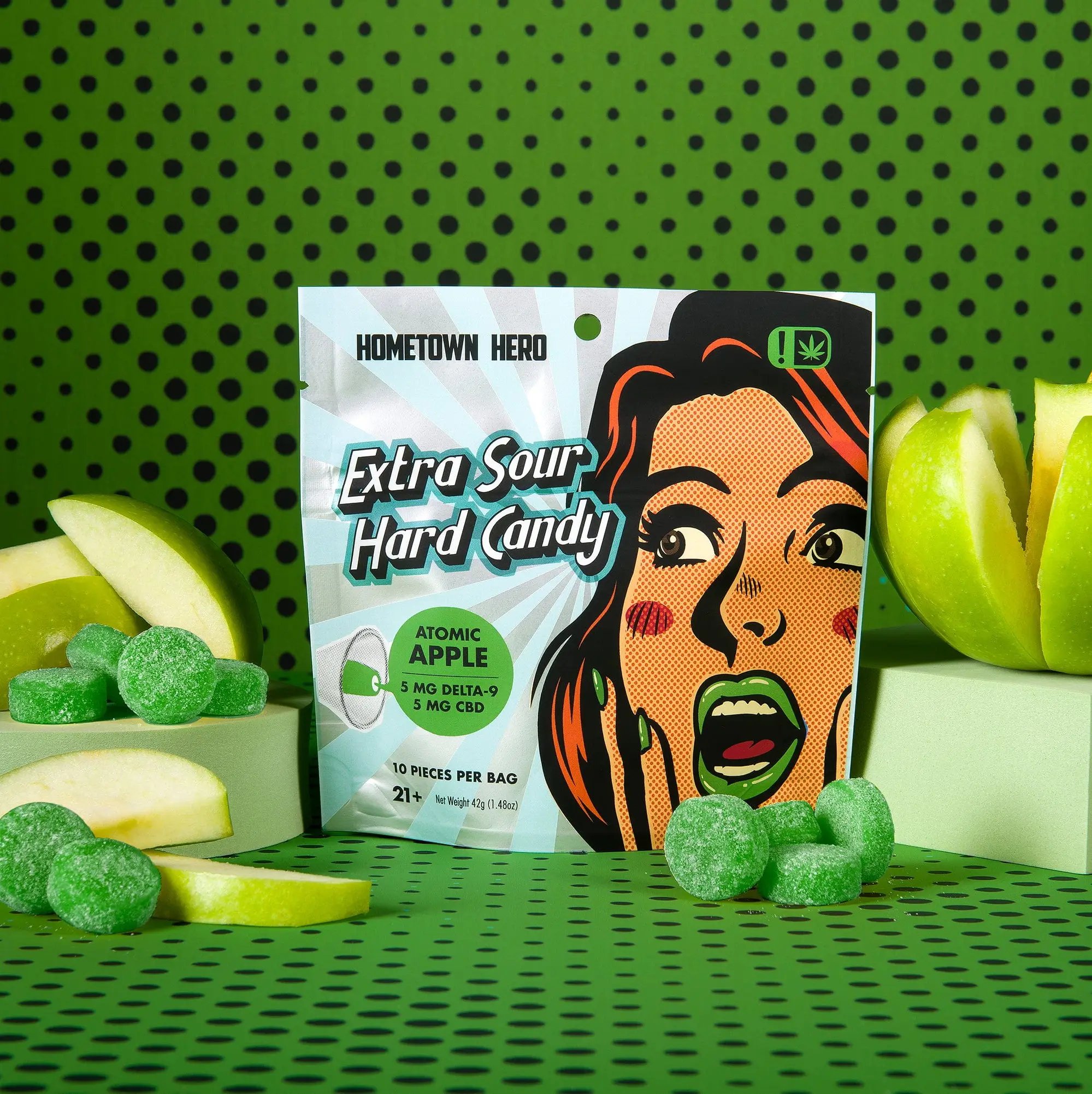 Green apples and edibles around a pack of Extra Sour Hard Candy