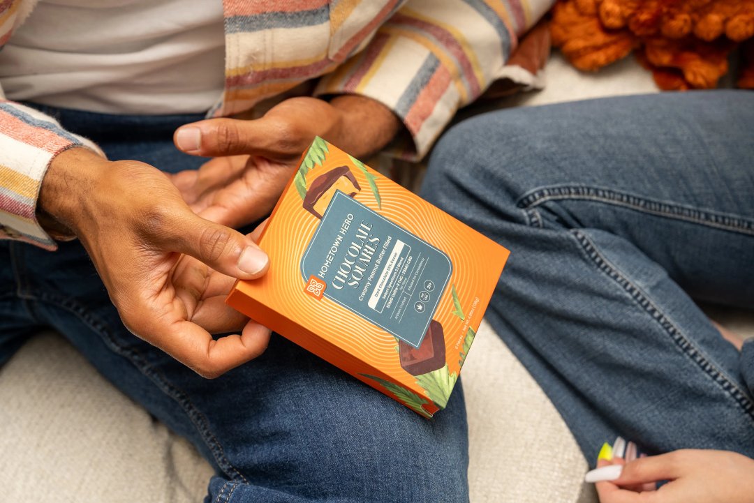 man holding box of chocolate edibles