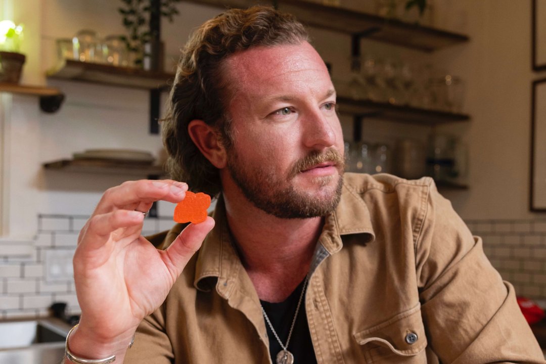 man holding a gummy