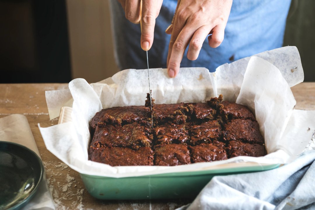 cutting a pan of homemade brownies