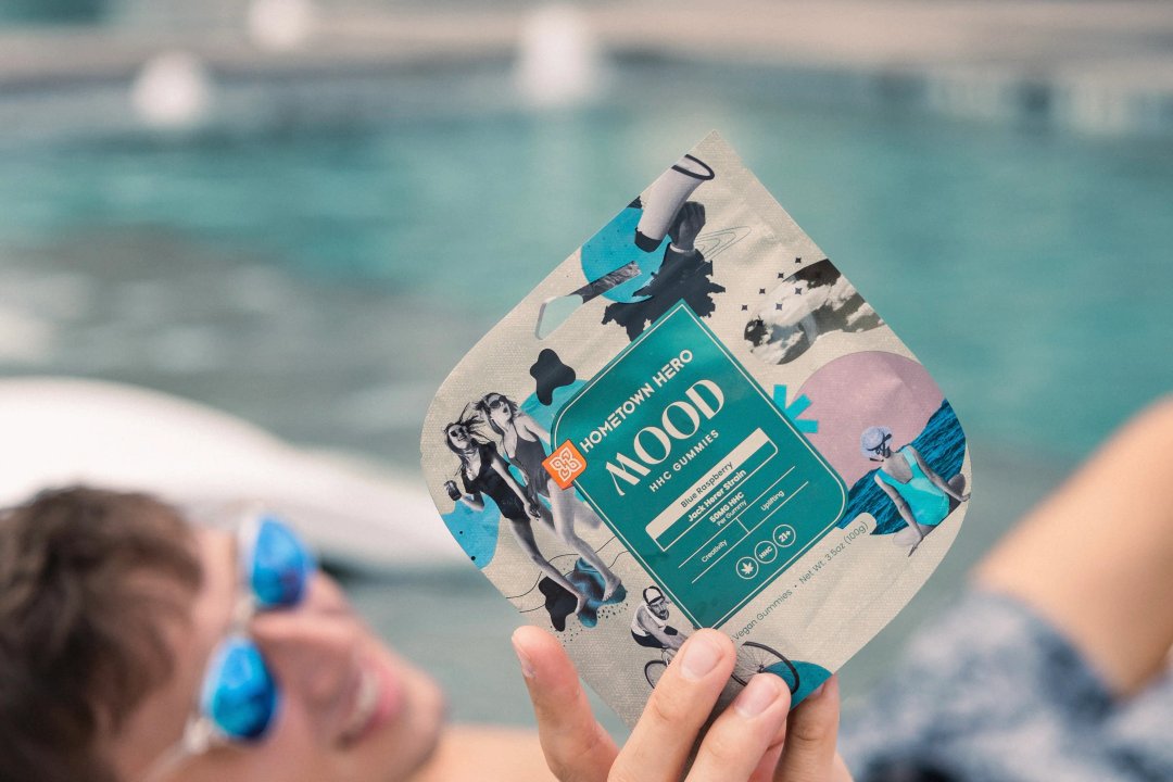 man holding jack herer edibles by the pool