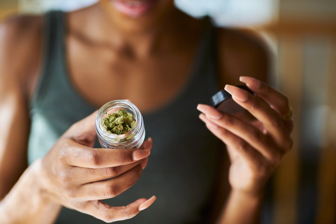 woman holding a glass of buds