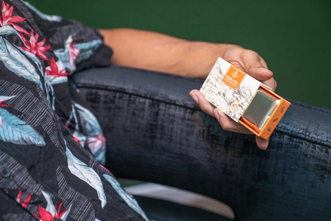 man holding kava + thc chocolate bar