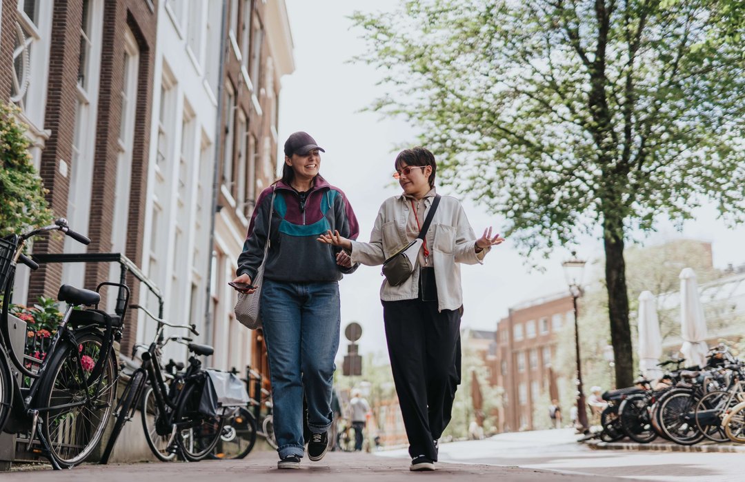 a couple of women strolling through the city talking