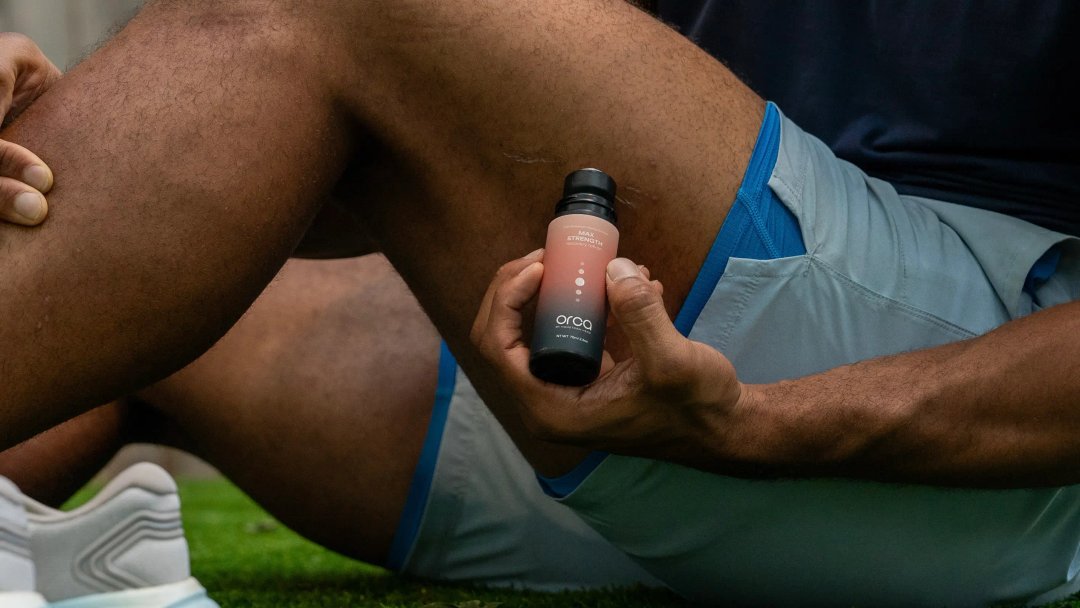 man applying a THC roll on to his quads