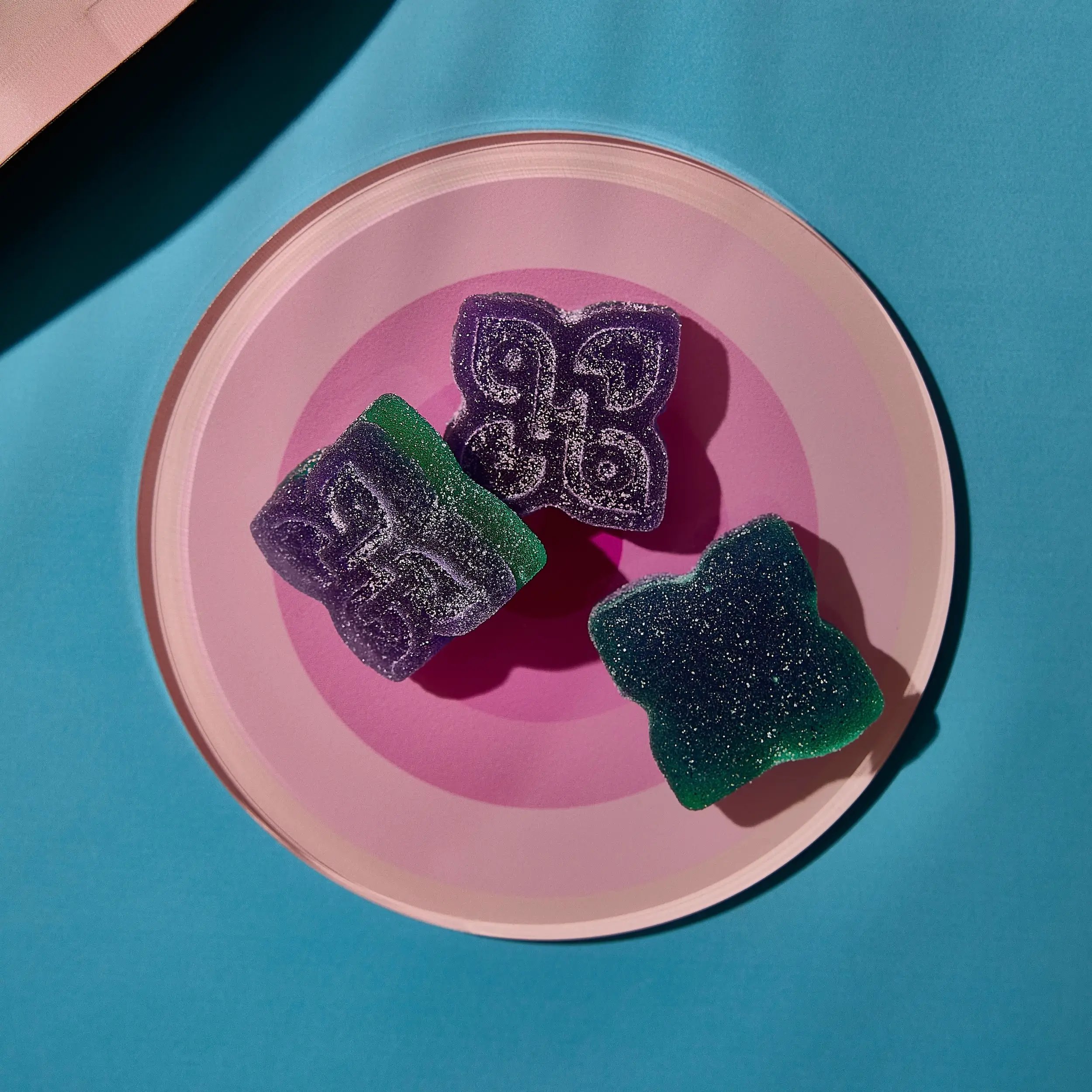 sugary purple green edibles on a plate