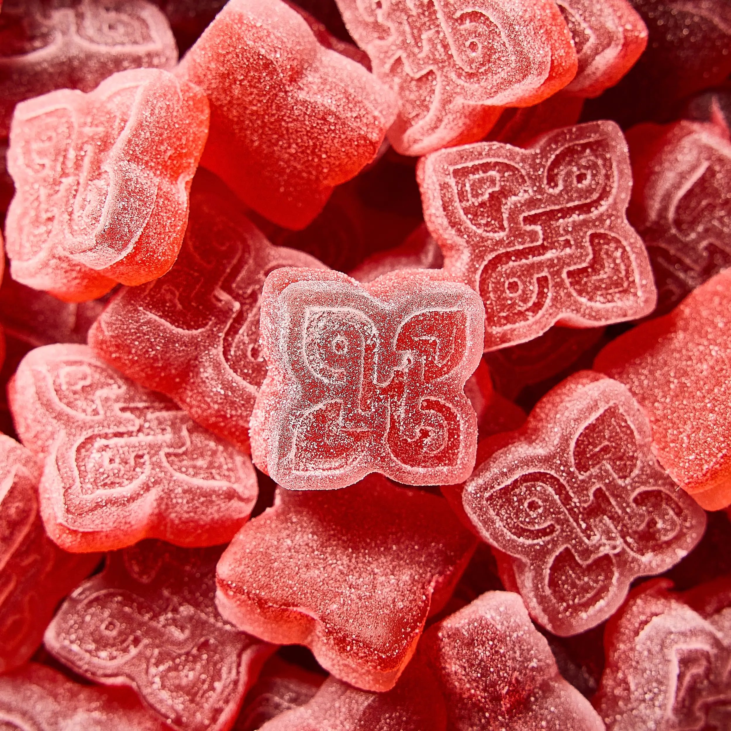 a pile of sugary red gummies