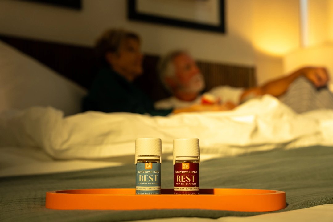 two bottles of sleep pills on a bed