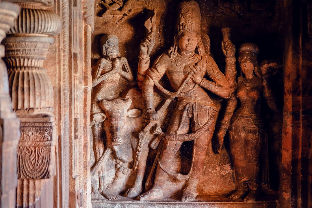 Sculptures of Shiva lord inside of 6th century Hindu temple in India. Architecture with carved walls in Badami