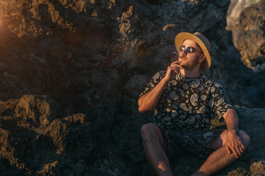 man smoking a joint in nature