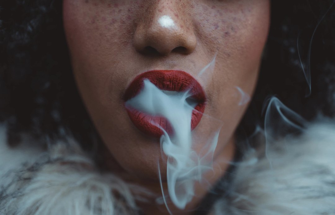 woman smoking, exhaling vapor