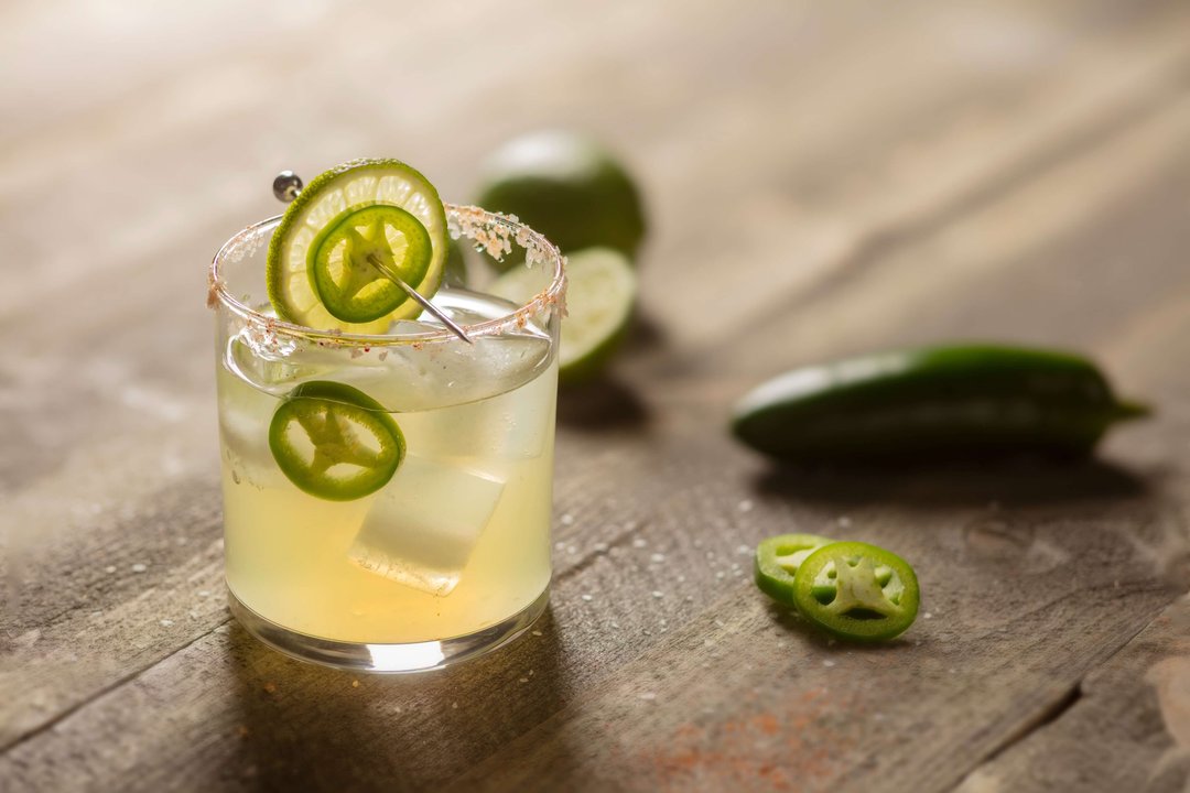 spicy margarita with lime, jalapeno and ice cubes