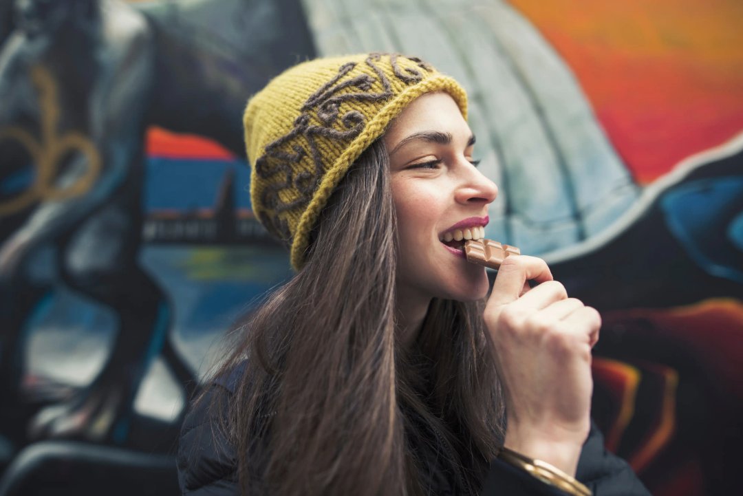 woman enjoying a chocolate bar