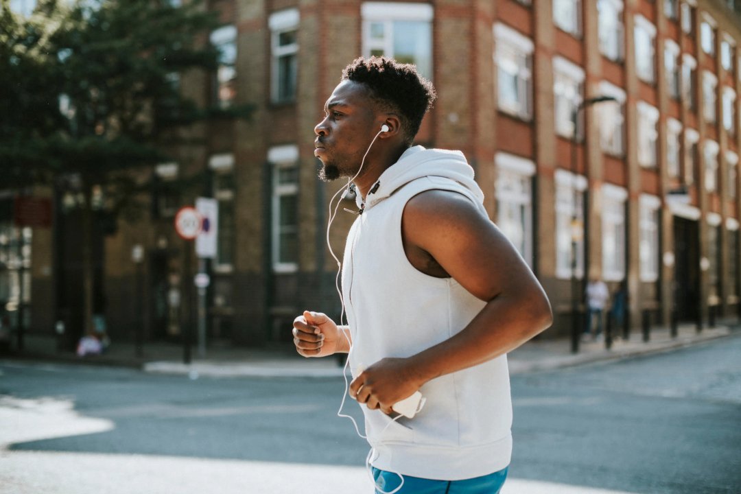 Athletic man running with earphones